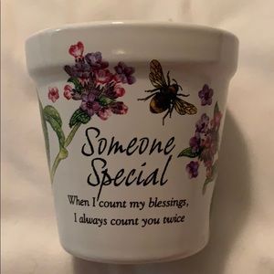 Stoneware pot with candle.